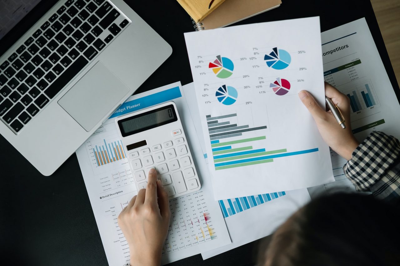 close-up-businessman-using-calculator-and-laptop-for-calculating-finance-tax-accounting